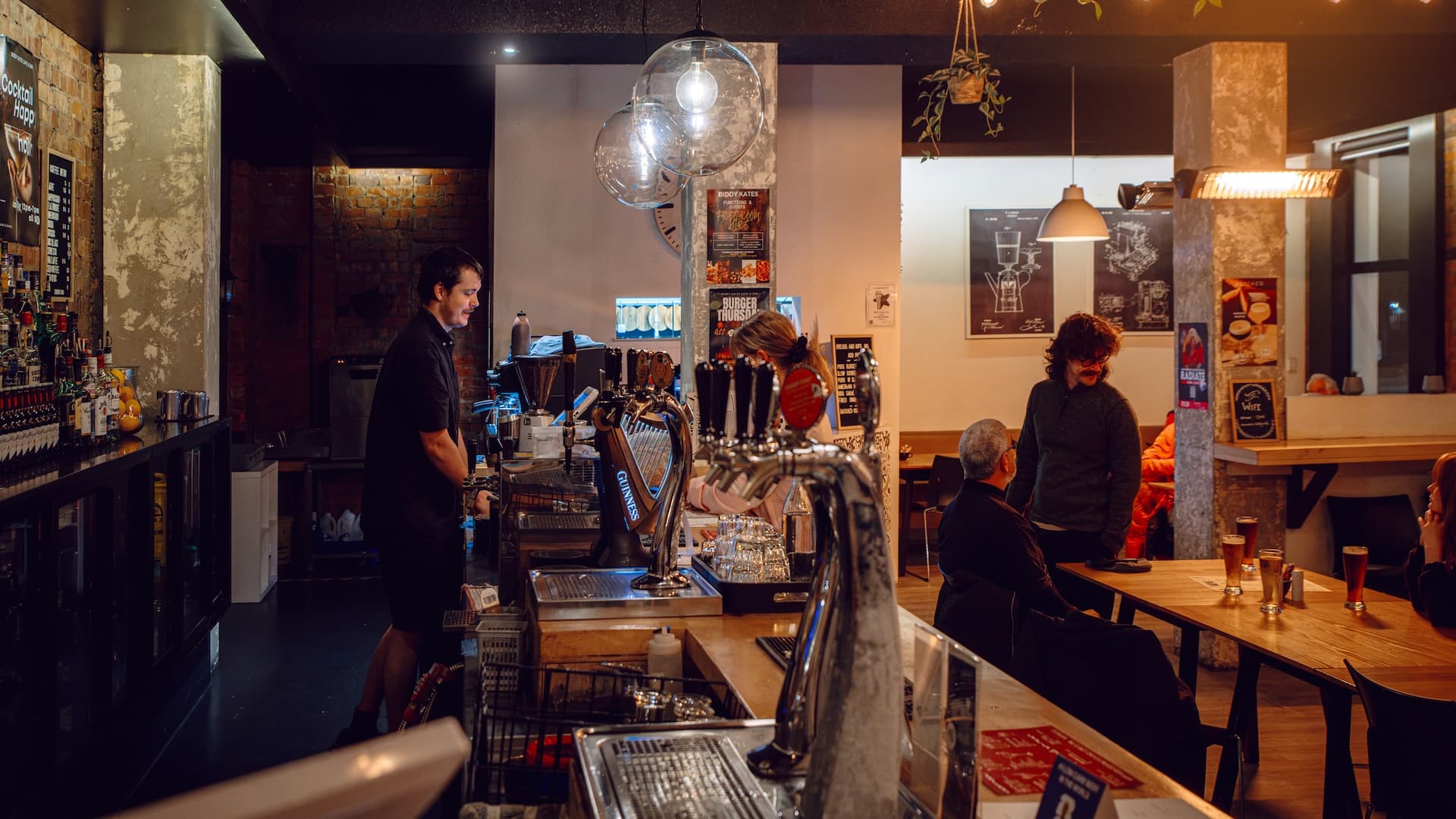 The bar at Biddy Kate's Cafe Bar in Blenheim, staff behind the counter with guests at tables